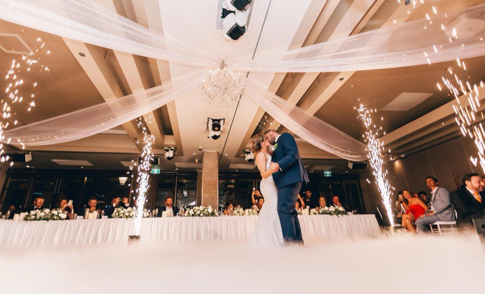 Bride and groom sharing their first dance under sparklers